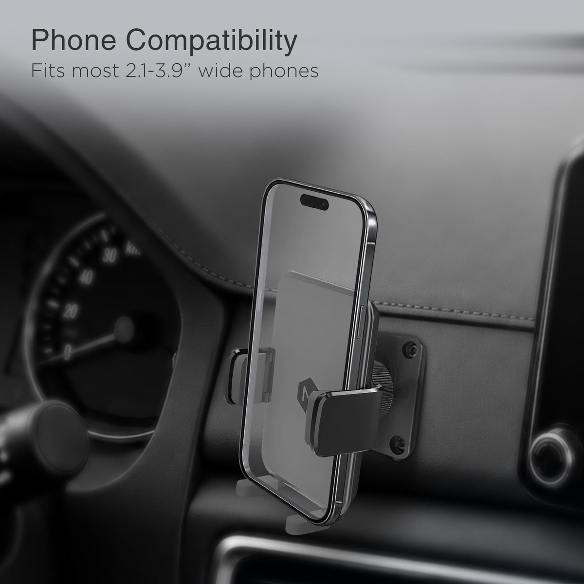 Close-up of vehicle dashboard with phone compatibility information, showing the car mount's adjustable cradle for 2.1 to 3.9 inch wide phones.