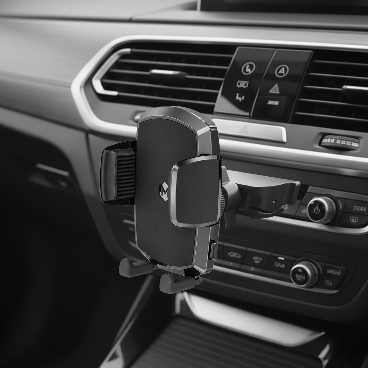 Close-up of vehicle dashboard with car mount attached, showing air vent clip and adjustable cradle for secure smartphone holding
